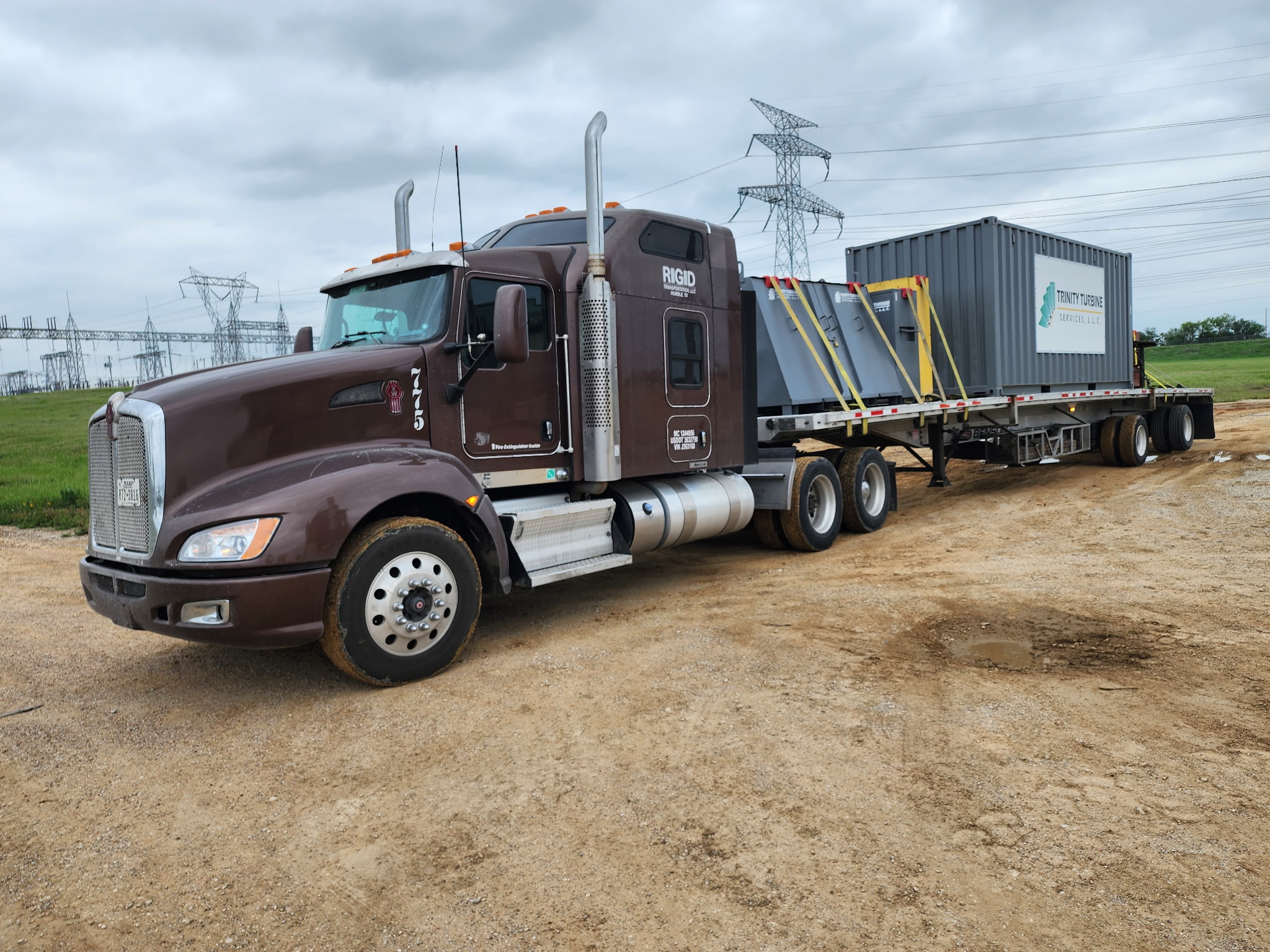 RIGID truck hauling freight on a flatbed trailer